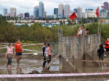 Climbing over a wall while wet and muddy was a challenge at the Spartan Race. a 5Km obstacle course, in Calgary over the weekend.