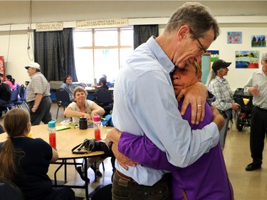 Provincial Liberal leader Dr. David Swann gets a hug from Christine Cuch at the annual Farmworkers Day BBQ at the Calgary Rehabilitation Centre Thursday August 20, 2015.