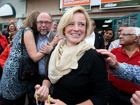 Alberta Premier Rachel Notley is all smiles as she meets NDP supporters at Bob Hawkesworth's campaign office.