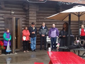 Former Calgary police chief and onetime provincial PC candidate Rick Hanson, in a gray jacket, looks on as Nirmala Naidoo, Liberal Party candidate for the federal riding of Calgary Rocky Ridge, launches her campaign in the rain at Symons Valley Ranch on Saturday, August 15, 2015.