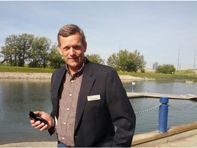 Rick Stamp, a farmer and chair of the irrigation council, pictured here in front of an irrigation canal in Calgary, has worked in an irrigation district for years and uses a smartphone app to control his pivots. (Erin Sylvester/Calgary Herald)