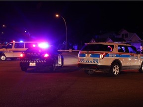 Police investigate a shooting in the 7000 block of California Blvd, N.E. Saturday night, August 22, 2015.