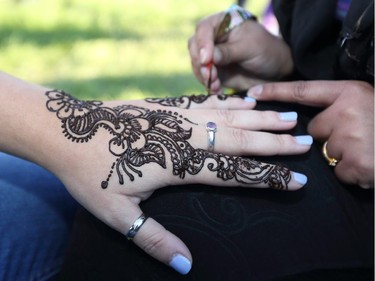 Sabah Bhatti applies a traditional Pakistan henna tattoo  to one of the many multicultural booths on display at GlobalFest Saturday night.