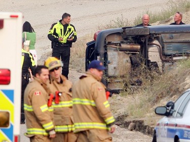 Police and Fire personel investigate a reported fatal accident from the Anderson Road onramp to northbound Deerfoot Trail Wednesday morning August 26, 2015. The vehicle left the ramp and came to rest inside the Lafarge plant property.