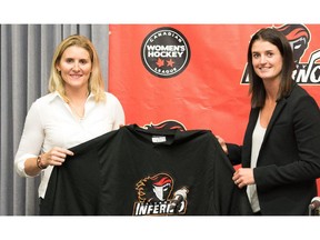 Hayley Wickenheiser, left, and Inferno assistant coach Gina Kingsbury pose with a team jersey during a press conference last month.