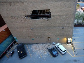 Vehicles damaged by bricks falling off the wall of a building at 6 ave. and 7 st. S.W., May 25, 2014.
