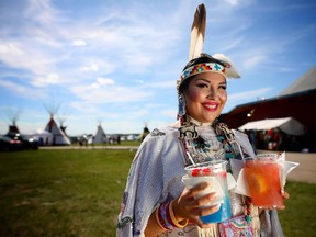 Sahvanne Weasel Traveller, from the Piikanni Nation and the 2010 Calgary Stampede Indian Princess, grabs some icy cold soft drinks before competing in women's traditional dance at the Siksika Nation Fair Powwow.