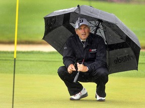 Defending Shaw Charity Classic winner Fred Couples took cover as the rains started on the eighth hole at Canyon Meadows during Thursday's Pro Am. He's one of the favourites going into Friday's opening round.