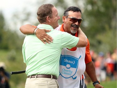 Champions Tour player Jeff Maggert, from Sea Pines, SC, hugged his caddy Rusty Uresti after he sunk his final putt on the 18th green to a final score of -16 to clinch the Shaw Charity Classic at the Canyon Meadows Golf and Country Club on August 9, 2015.