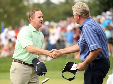 Champions Tour player Jeff Maggert, from Sea Pines, SC, was congratulated by Colin Montgomerie after Maggert sunk his final putt on the 18th green to a final score of -16 to clinch the Shaw Charity Classic at the Canyon Meadows Golf and Country Club on August 9, 2015.
