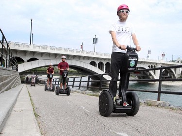 Peter Kominek,trains a family from Ottawa, Nathan, Lia and their dad William Chan to ride Segways on Calgary's bike systems, in Calgary on August 10, 2015.