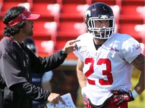 Calgary Stampeders special-teams co-ordinator Mark Kilam instructs running back William Langlais during practice at McMahon Stadium on Wednesday, as Calgary prepares to face the Riders in Regina on Saturday.