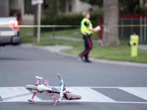 Members of the Calgary Police Service investigated after a woman and two children were struck by a vehicle while crossing a Temple crosswalk on July 29, 2015.