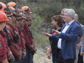 Prime Minister Steven Harper and B.C. Premier Christy Clark greet firefighters in West Kelowna, B.C. Even Harper had to admit, when asked by reporters if global warming was contributing to forest fire intensity, that, “I think it’s possible.”