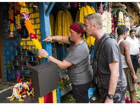 Cynthia and Brian assemble a garland at the Mallick Flower Market in Kolkata, India on The Amazing Race Canada.