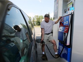 Dan Roach fills up at Esso gas station at Silver Springs in Calgary on August 13, 2015.