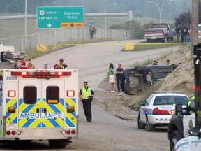 CALGARY, AB.; AUGUST Police and fire personnel investigate a crash from the Anderson Road onramp to northbound Deerfoot Trail on Aug. 26. The vehicle left the ramp and came to rest inside the Lafarge plant property.