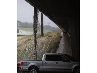 Heavy rain and hail pours off the 16th Avenue overpass on Deerfoot Trail in Calgary on Tuesday, Aug. 4, 2015.