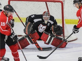 Goaltender Kyle Dumba tracks the puck through traffic during Hitmen training camp in Calgary on Monday, Aug. 25, 2014.