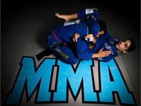 Rising Brazilian Jiu Jitsu star Jorgji Qiro, right, practices a triangle choke with sparring partner Sam Franchi at MMA University in Calgary.