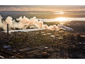 The setting sun reflects off a tailings pond behind Syncrude's oilsands upgrading facility north of Fort McMurray.