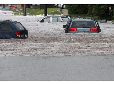 Vehicles are abandoned in flood waters along 5th avenue N.E. near 36th street after a powerful thunder and hail storm moved through the city on Tuesday afternoon.