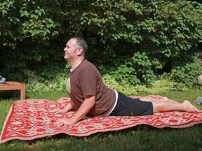 Gavin Young, Calgary Herald CALGARY, AB: JULY 14, 2015 - Hart Steinfeld demonstrates the cobra pose for Johanna Steinfeld's August yoga column. Gavin Young/Calgary Herald)  (For You section story by Johanna Steinfeld) Trax# 00066854A