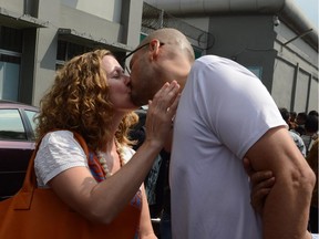 Freed Canadian school administrator Neil Bantleman (R) and wife Tracy Bantleman (L) kiss outside Jakarta's Cipinang prison on August 14, 2015 following his release from jail. Bantleman, who also holds British nationality, and Indonesian teaching assistant Ferdinand Tjiong were jailed for 10 years each in April and ordered to pay a hefty fine.