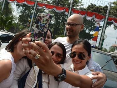 Freed Canadian school administrator Neil Bantleman (R) poses for a selfie with a group of parents and supporters outside Jakarta's Cipinang prison on August 14, 2015 following his release from jail. Bantleman, who also holds British nationality, and Indonesian teaching assistant Ferdinand Tjiong were jailed for 10 years each in April and ordered to pay a hefty fine.