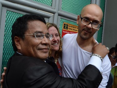 Freed Canadian school administrator Neil Bantleman (R) with his wife Tracy Bantleman (C) and Indonesian lawyer Hotman Paris (L) hug outside Jakarta's Cipinang prison on August 14, 2015 following his release from jail. Bantleman, who also holds British nationality, and Indonesian teaching assistant Ferdinand Tjiong were jailed for 10 years each in April and ordered to pay a hefty fine.