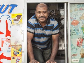 Truck owner Kiruba Sabarattinam takes ice cream orders at a southwest Calgary housing complex.