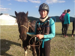 Liz Brown, a former Calgary journalist, crosses the finish line at the Mongol Derby, the world's longest horse race, in August 2015.