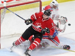 Czech Republic goalie Vitek Vanecek, left stops a shot from Canada's Jayce Hawryluk, left as  Czech Republic's Jan Scotka slides in during their game at Markin MacPhail Centre on Tuesday. Canada won 7-1 in another crucial scouting opportunity for Hockey Canada's bird-dogs.