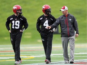Dave Dickenson, who is set to be inducted into the Canadian Football Hall of Fame, has been a mentor to Stamps quarterbacks Bo-Levi Mitchell, left, and Drew Tate, centre.