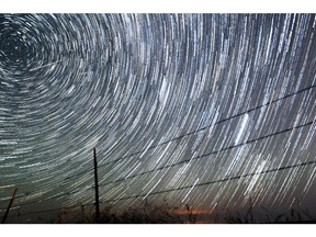 Meteors streak above the Wyoming countryside in this time-elapsed photo, during the peak of the Perseids Meteor Shower in August 2013.