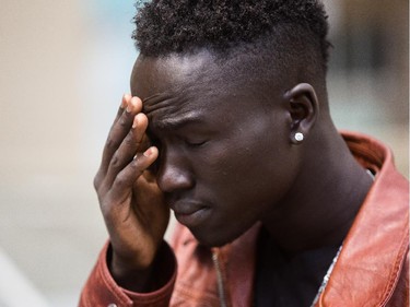 Chatim Metkurjock Thor reacts to the sentencing in the manslaughter of his brother Gatleak Metkurjock Thor at the Calgary Courts Centre in Calgary on Monday, August 17, 2015.