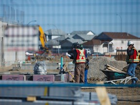 Construction workers build a new school in NE Calgary.