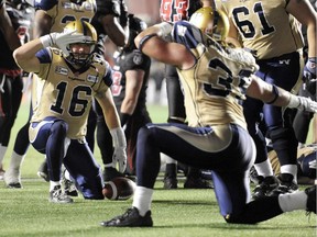 Winnipeg Blue Bombers' Robert Marve, left, and Michel-Pierre Pontbriand celebrate Marve's touchdown against Ottawa Redblacks during first half CFL action in Ottawa on Friday, Oct. 3, 2014.