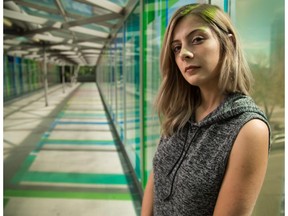 Natalie Lauchlan, artist in residence at the Arts Commons, poses in the near the Ledge Gallery, where her work titled '2' is on display, in Calgary on Wednesday, Aug. 19, 2015.