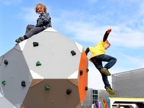 Kids challenge themselves with unstructured play as they climb giant molecule climbing blocks at the Telus Spark Brainasium in Calgary on August 4, 2015.