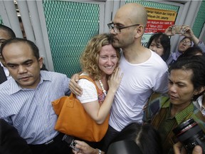 Canadian teacher Neil Bantleman, right, hugs his wife Tracy, left, after he was released from Cipinang prison in Jakarta, Indonesia, on Aug.14, 2015. Indonesia's Supreme Court has overturned his acquittal.