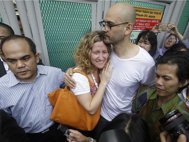 Canadian teacher Neil Bantleman, right, hugs his wife Tracy, left, after he was released from Cipinang prison in Jakarta, Indonesia, Friday,Aug.14, 2015. A Canadian teacher and an Indonesian teaching assistant serving 10 years in an Indonesian prison for child sexual offenses were released Friday after a court overturned their convictions.