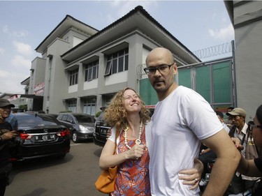 Canadian teacher Neil Bantleman, right, hugs his wife Tracy, left, after he was released from Cipinang prison in Jakarta, Indonesia, Friday,Aug.14, 2015. A Canadian teacher and an Indonesian teaching assistant serving 10 years in an Indonesian prison for child sexual offenses were released Friday after a court overturned their convictions.