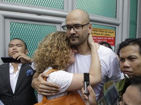 Canadian teacher Neil Bantleman, right, hugs his wife Tracy, left, after he was released from Cipinang prison in Jakarta, Indonesia in August, 2015.