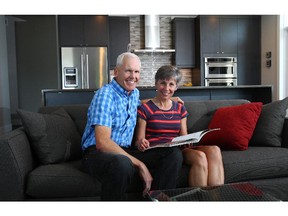 Warren and Donna Grasdal pose in the living room of their new condo at Overture.