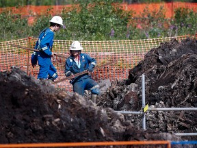 Crews work to contain and clean up a pipeline spill at Nexen Energy's Long Lake facility near Fort McMurray on July 22, 2015.