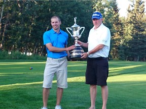 Sean Samoluk, left, accepts the city amateur trophy from Calgary Golf Association's vice-president Jim Finney on Sunday at Priddis Greens.