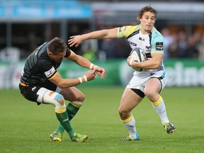 Calgarian Jeff Hassler of the Ospreys moves past James Wilson during the European Rugby Champions Cup match between Northampton Saints and Ospreys at Franklin's Gardens last October.