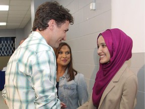 Federal Liberal leader Justin Trudeau shakes hands on July 3 with Ala Buzreba of Calgary Nosehill, then the youngest Liberal candidate in the country, during a Stampede stop at the Akram Jomaa Islamic Centre.