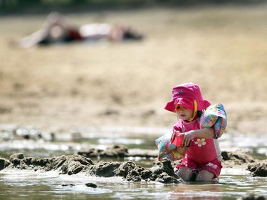 Three-year-old Lily Guilford played in the sand at Sikome Lake as temperatures climbed again above 20C on August 17, 2015.